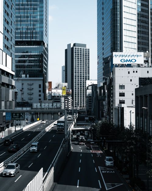 Free Cityscape of Tokyo with tall skyscrapers and bustling streets on a clear day. Stock Photo