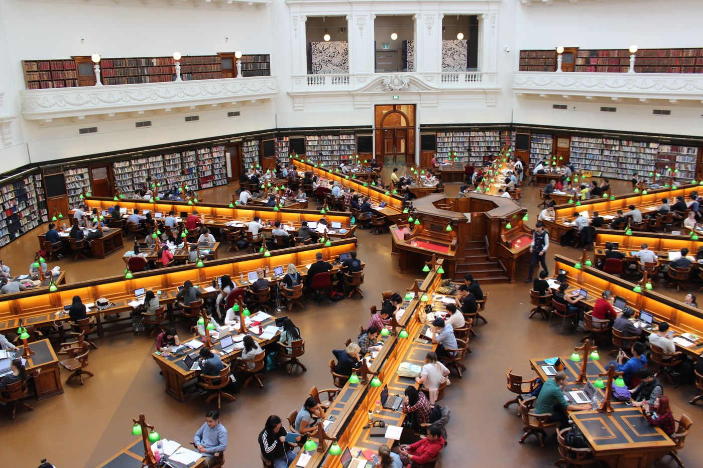 Students reading at long tables in a school library
