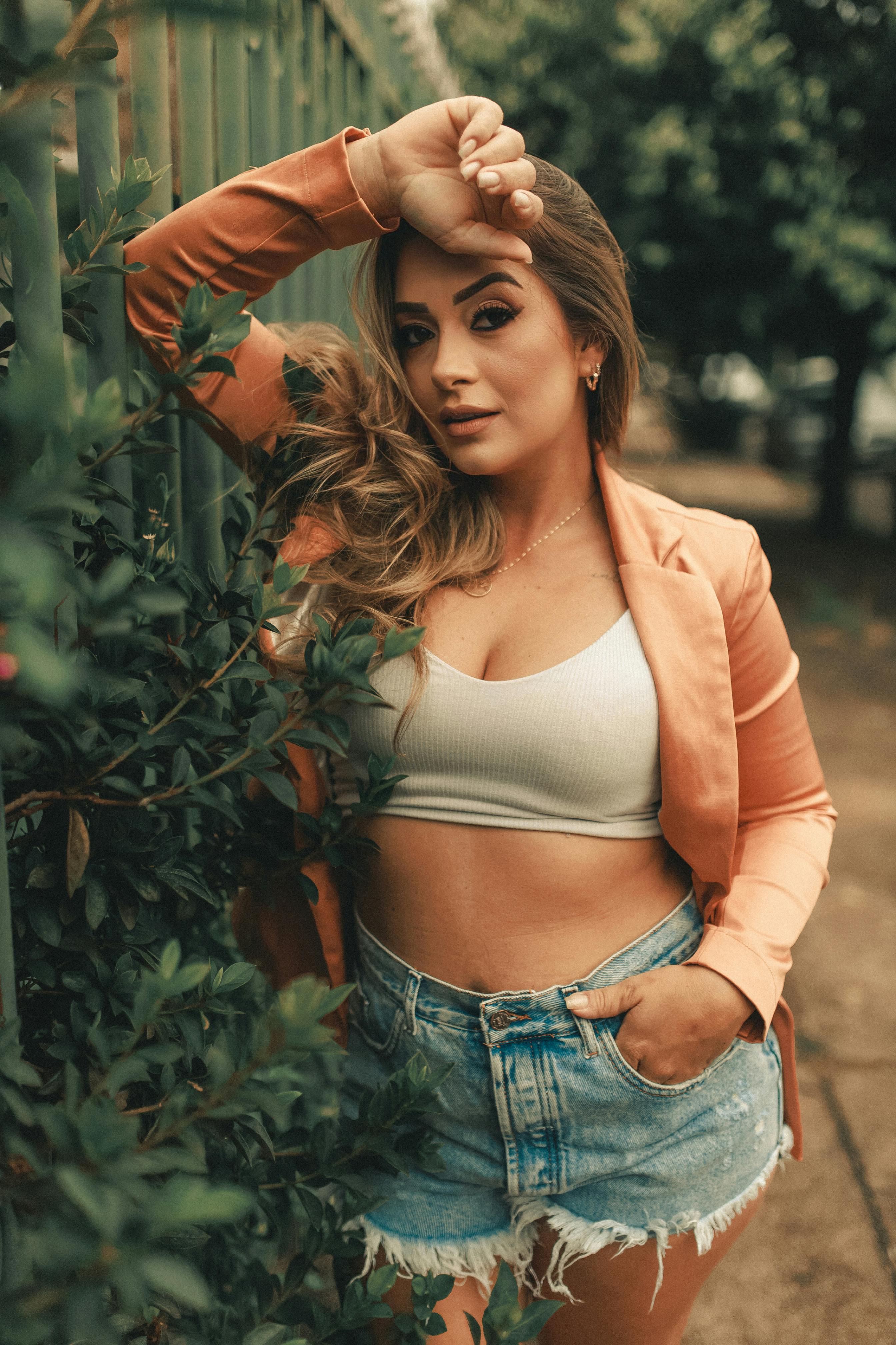 Brunette slim model in jeans and sports bra. Stock Photo by