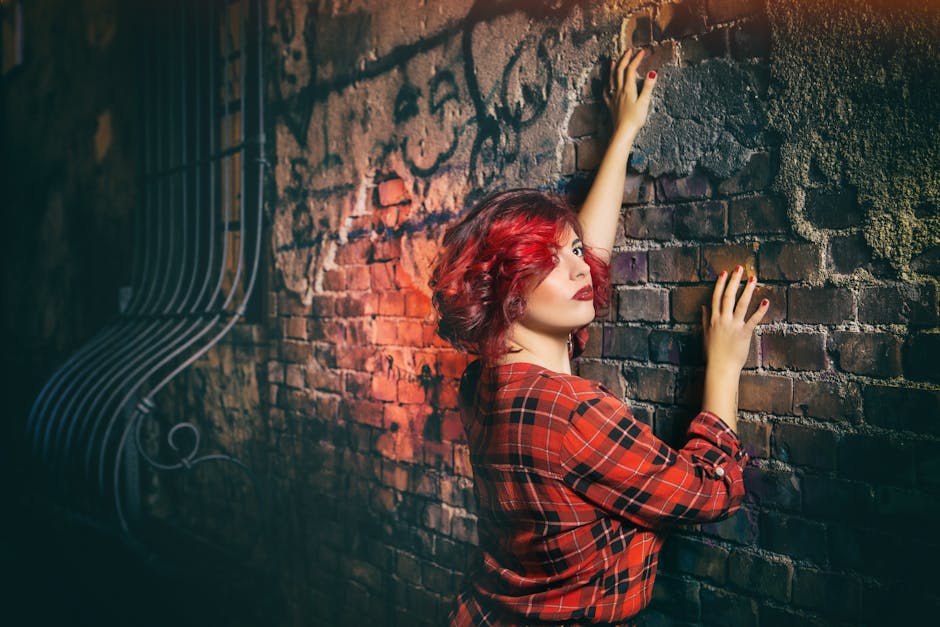 Woman in Red Black and White Plaid Holding Gray Concrete Wall