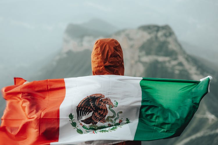 Head Of A Hooded Person Holding A Mexican Flag