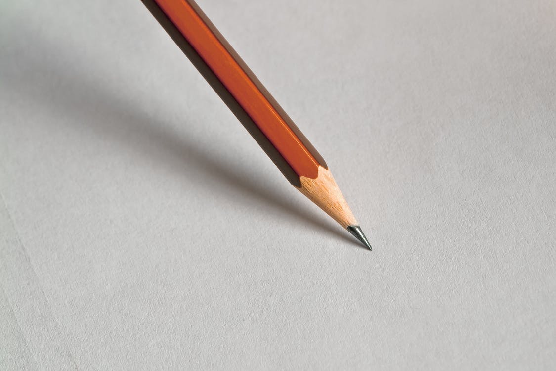 Free Pencil on White Paper Stock Photo