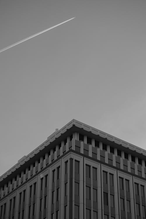 Contrail over Building in Black and White