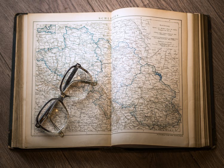 Black Framed Eyeglasses Map In Book