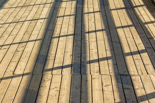 Sunlight and Shadow on Wooden Pier
