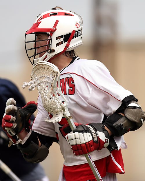 Free Man Wearing White and Red Lacrosse Uniform Stock Photo