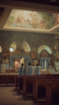 Priests standing in the ornate interior of an Ethiopian Orthodox church in Addis Ababa.