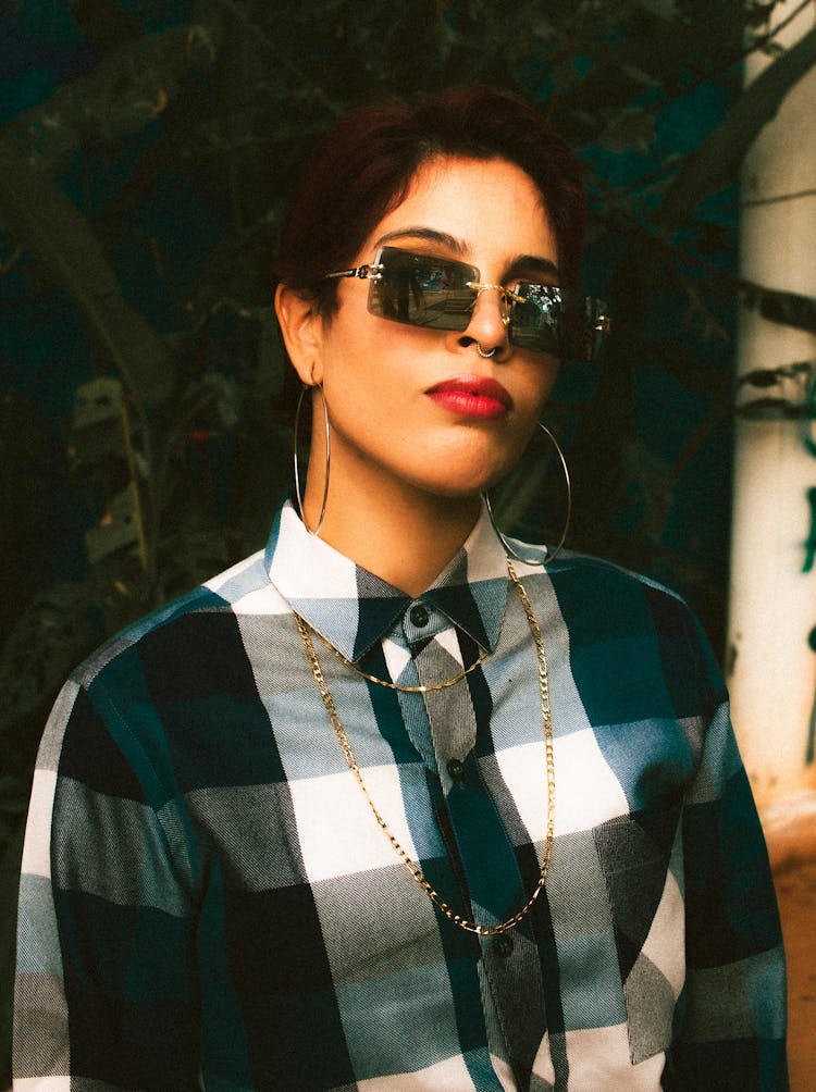 A Woman In A Checked Shirt With Red Liptick