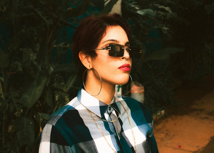 A Woman In A Checked Shirt With Red Liptick