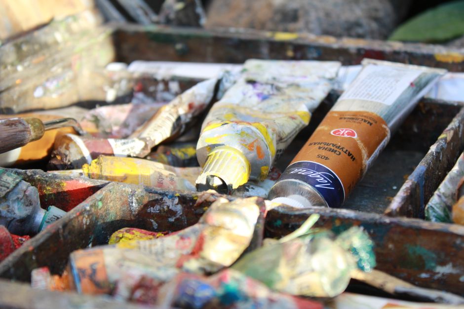 A close-up view of colorful paint tubes in an artist's box, perfect for creative projects.
