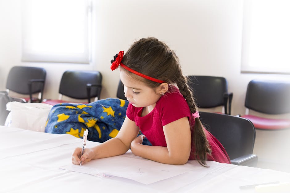 Girl in Red Short Sleeve Dress and Flower Headband Holding Pen and Writing on Paper on Table