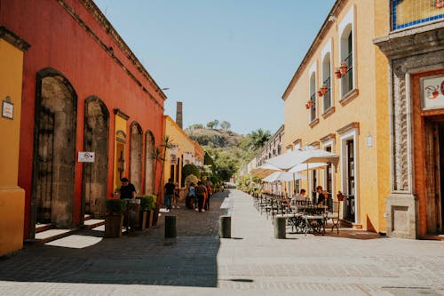 View of a Street between Red and Yellow Buildings in Tequila Town, Jalisco, Mexico 
