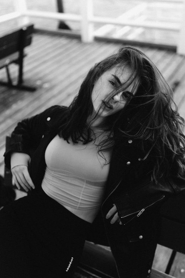 Photo Of An Attractive Young Woman Sitting On A Bench