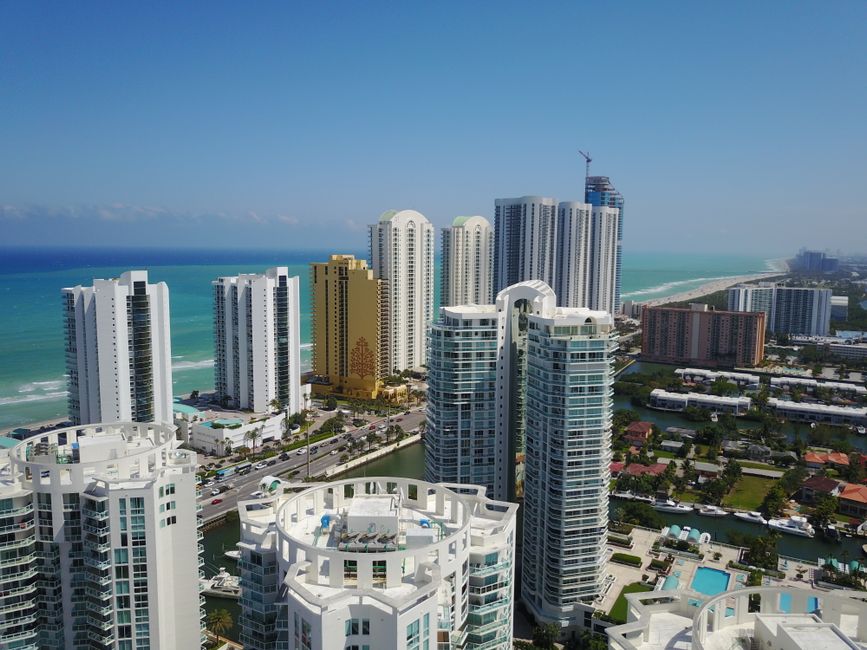 Unforgettable Miami Helicopter Experience with Transportation and Champagne Review Review 2026 - Aerial view of modern Sunny Isles Beach skyline with ocean in background.