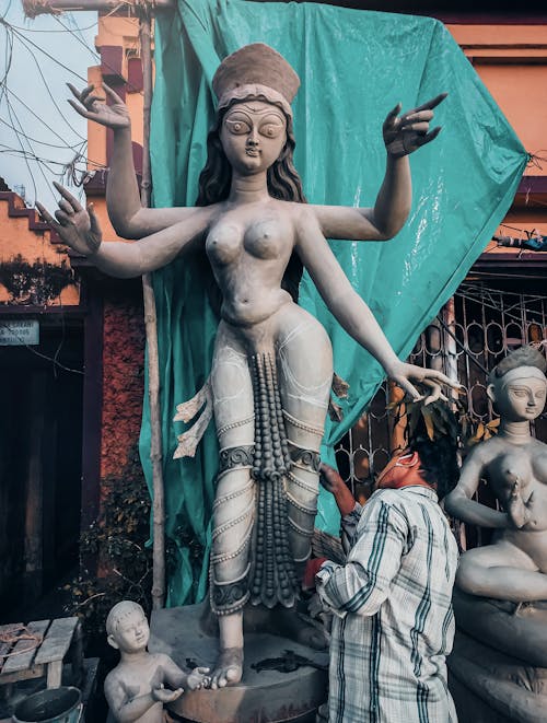 Man Creating a Sculpture of a Goddess 