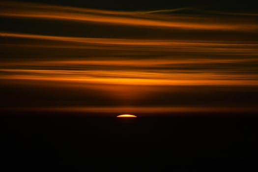 A stunning sunset with dramatic orange and yellow hues across the sky.