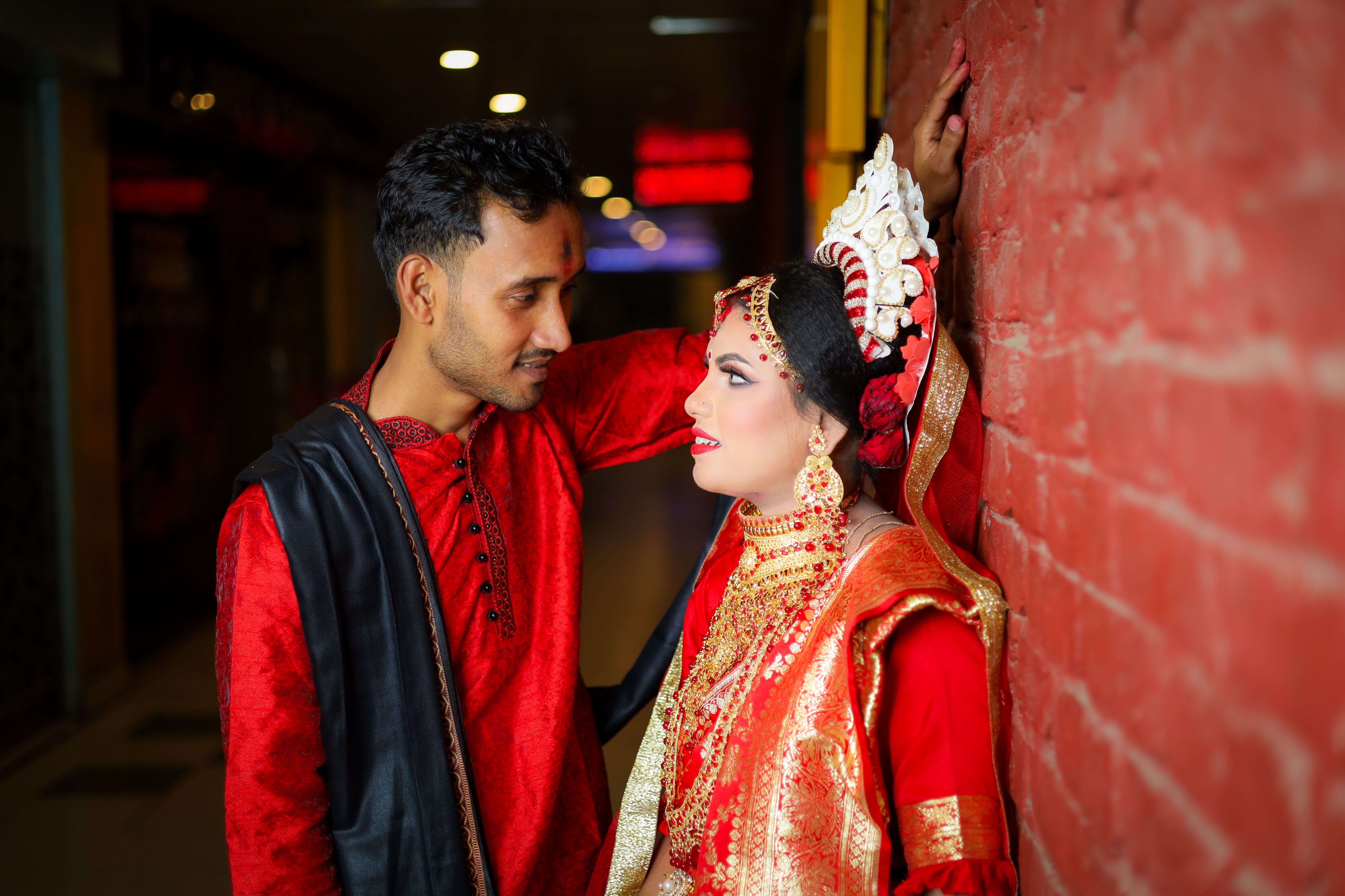 A Couple in Traditional Clothing Sitting on Steps · Free Stock Photo