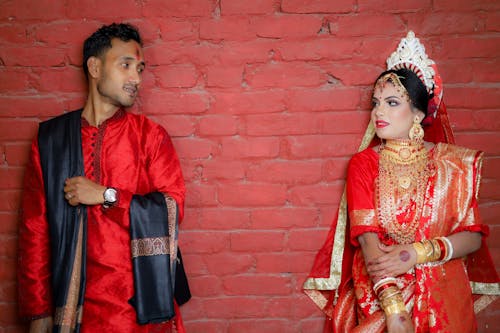 Woman and Man Posing in Traditional Clothing