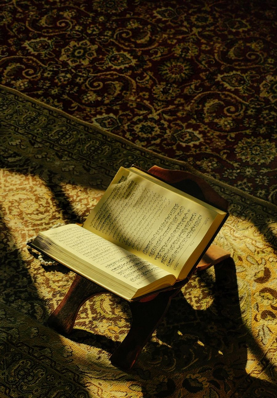 Open Quran on a wooden stand during Quran memorization