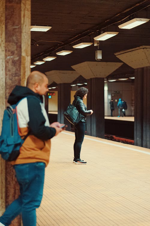 People Waiting on a Platform at a Subway Station 