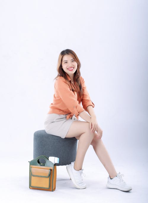 Smiling Woman Sitting on a Stool