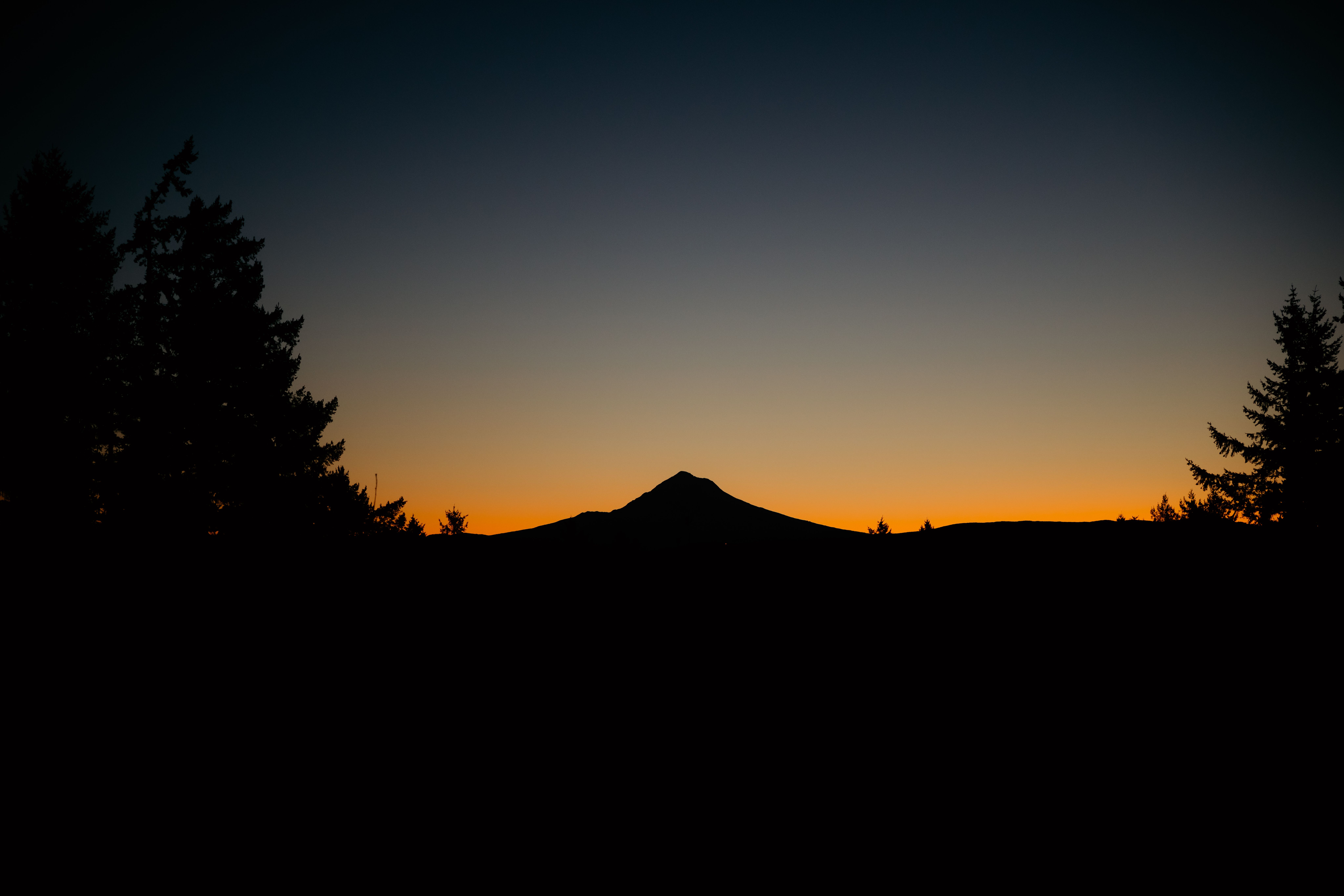Silhouetted Hill and Trees at Sunset · Free Stock Photo