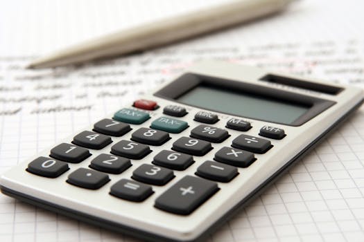 White and Black Desk Calculator on White Graphing Paper