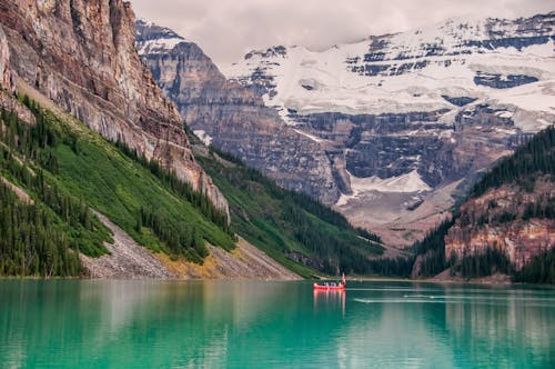 Red Boat In The Lake Near Mountain