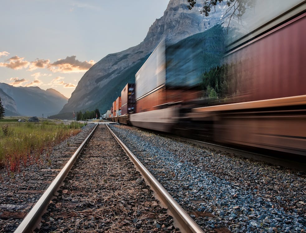 Free Passing Train on the Tracks Stock Photo