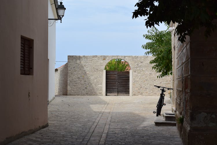 Wooden Gate In The Stone Fence Wall