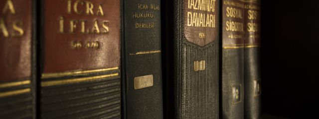 Detailed close-up of law and regulation books on a bookshelf, emphasizing education and knowledge.