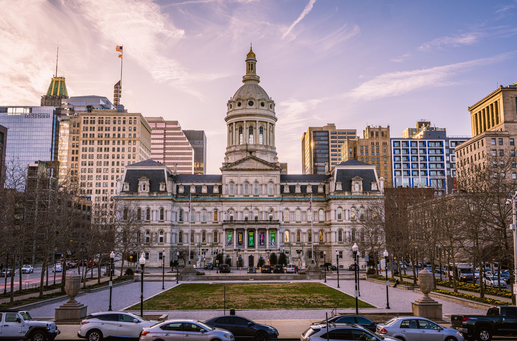 Baltimore City Hall with its domed tower and the downtown skyline behind it.