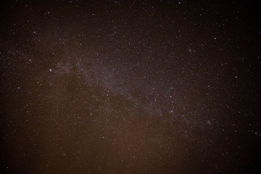 Explore the vastness of the starry night sky featuring the Milky Way galaxy's brilliance.