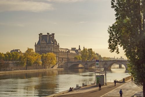 Free Stunning view of the Louvre and Seine River at sunset, capturing the essence of Parisian charm. Stock Photo