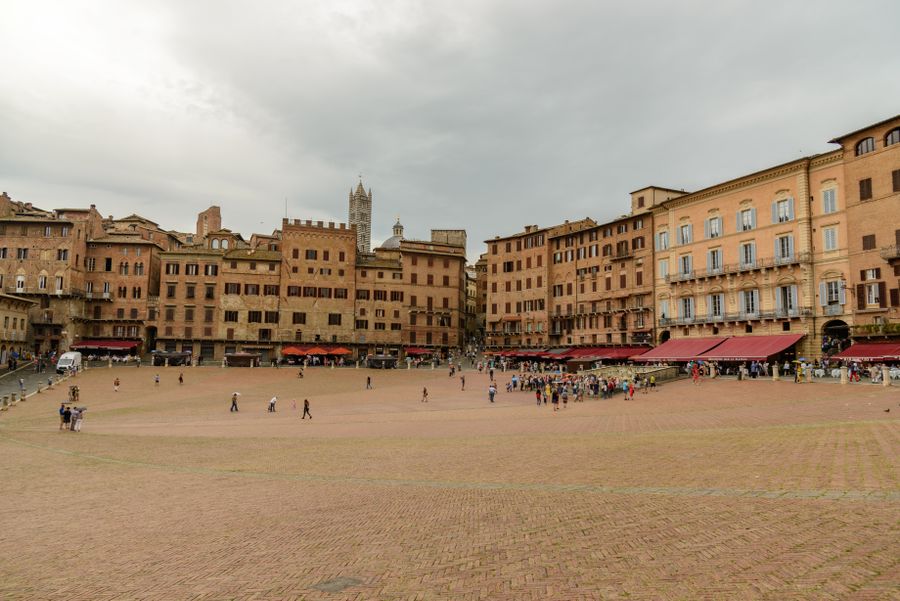 Video still of travellers crossing a historic European square — photo by Petr Ganaj on Pexels