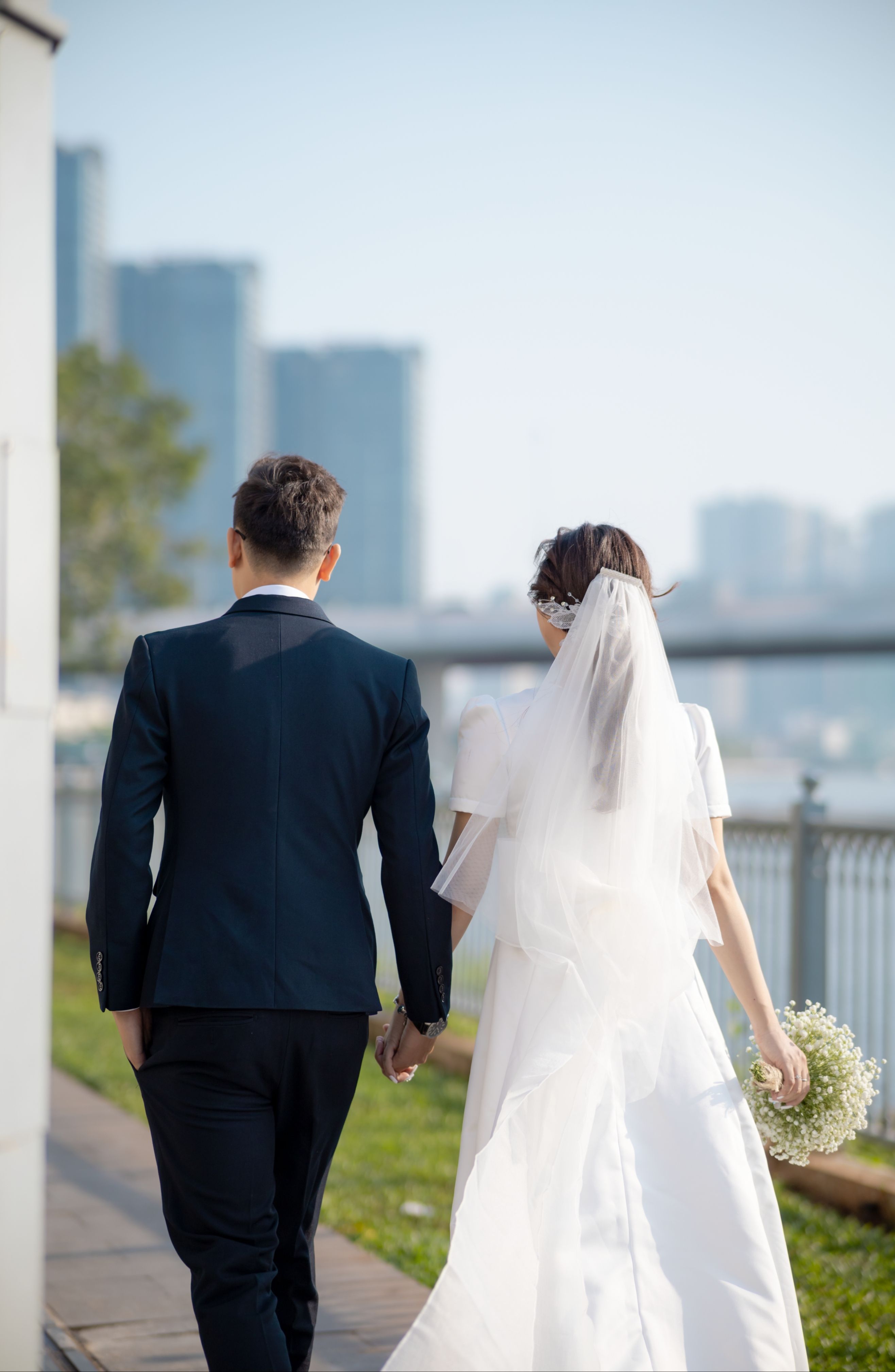 Back View of Bride and Groom Walking in City and Holding Hands · Free ...