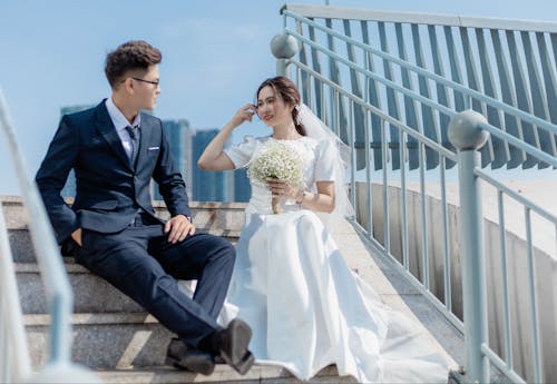 Bride and Groom Sitting on Steps