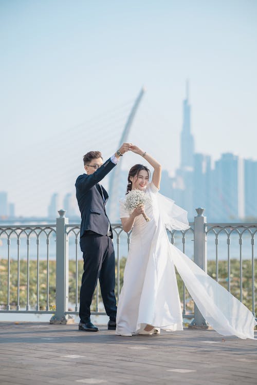 Newlyweds Dancing on a Bridge