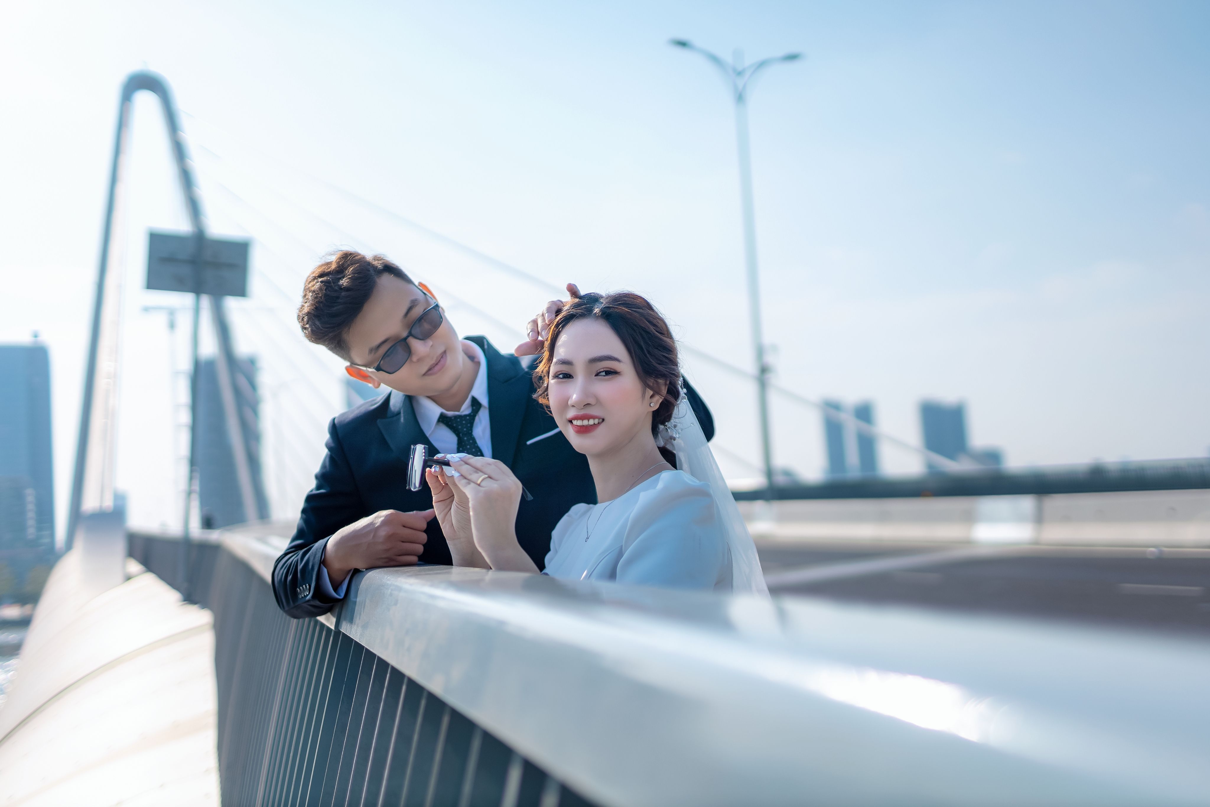 Newlyweds Standing Behind a Bridge Railing · Free Stock Photo