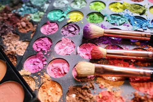 Brushes Lying on Colorful Make-Up Palette