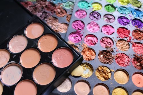 Free Close-up view of colorful makeup palettes with cracked pigments, ideal for beauty and cosmetics content. Stock Photo