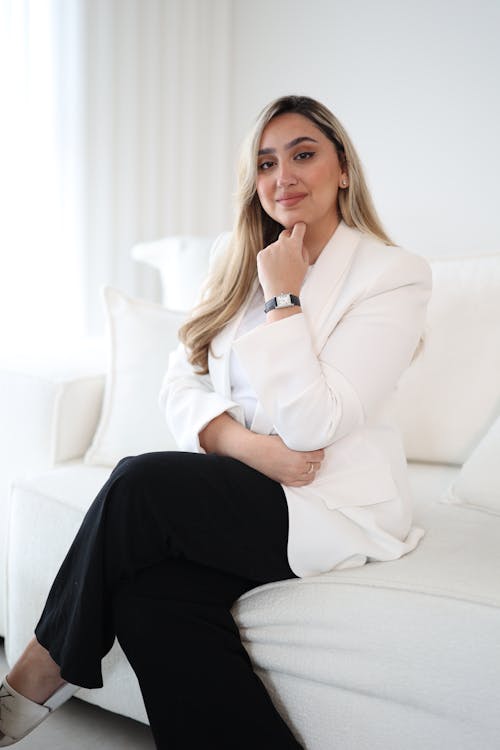 Blonde Woman Posing in Suit on Couch