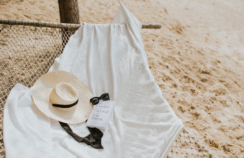 Free Ribbon, Book, Sunglasses and Hat on Hammock Stock Photo