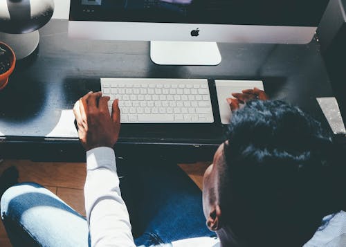 Free Man in White Dress Shirt Facing Turned on Silver Imac Stock Photo