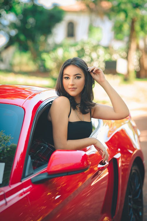 A Young Woman in a Red Car