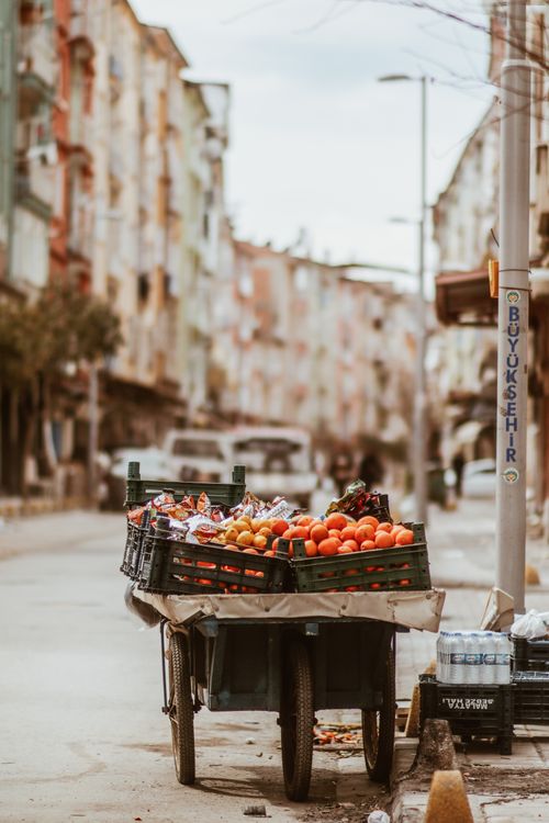 Free A vibrant street fruit cart filled with fresh produce in a lively city ambiance. Stock Photo