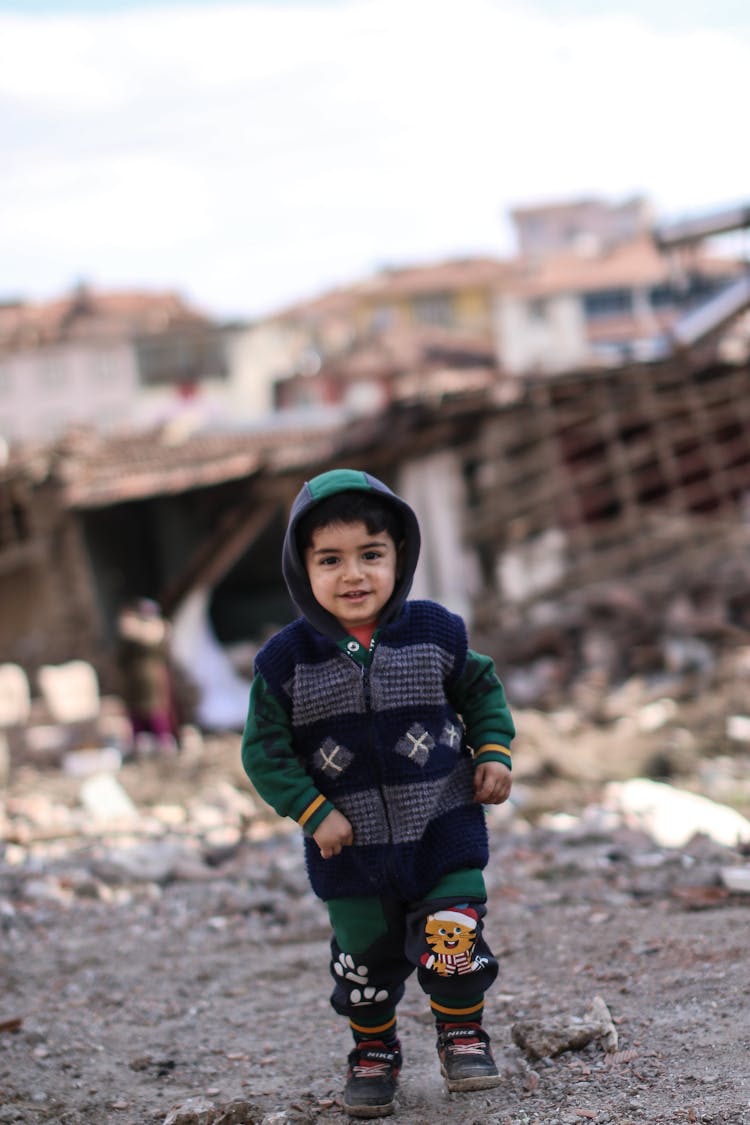 A Little Child In Front Of Destroyed City