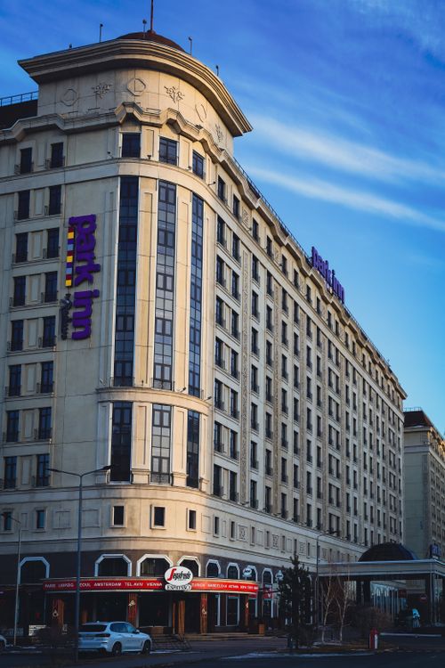 Free A striking facade of Park Inn by Radisson hotel under a clear sky in Astana's urban environment. Stock Photo