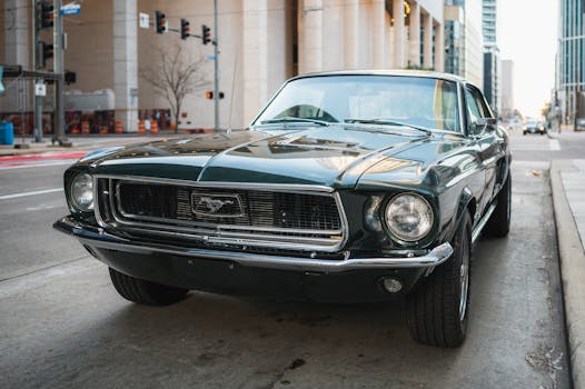 A vintage green Ford Mustang parked in a city street, showcasing retro urban style.
