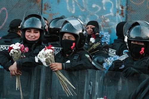 Police Officers Holding Flowers